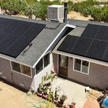 West Hollywood home with rooftop solar panels under sunny skies